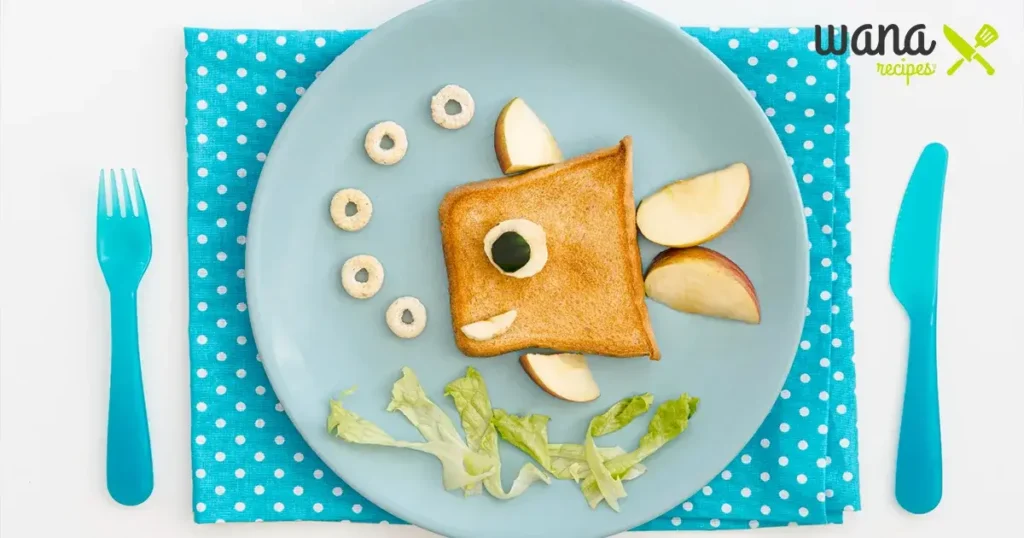 Fish-themed kid-friendly meal featuring toast, apple slices, and lettuce for fun toddler lunch ideas.