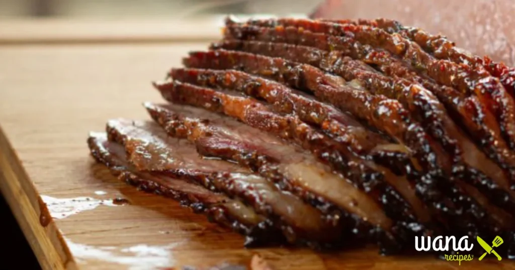 Raw brisket coated with a beef bouillon dry rub, prepared for smoking.