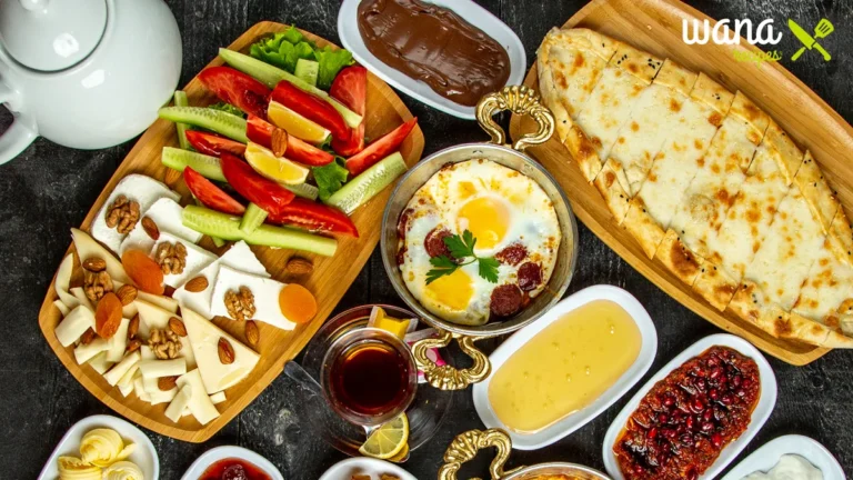 A vibrant Balkan breakfast spread featuring flaky burek, creamy kajmak, tangy ajvar, fresh bread, pickled vegetables, eggs, and a steaming cup of Turkish coffee, beautifully arranged on a rustic wooden table.