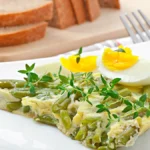 Fresh edamame egg salad served in a bowl with a garnish of herbs and sesame seeds.