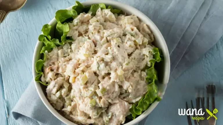 Rotisserie chicken salad served in a white bowl with fresh vegetables and creamy dressing