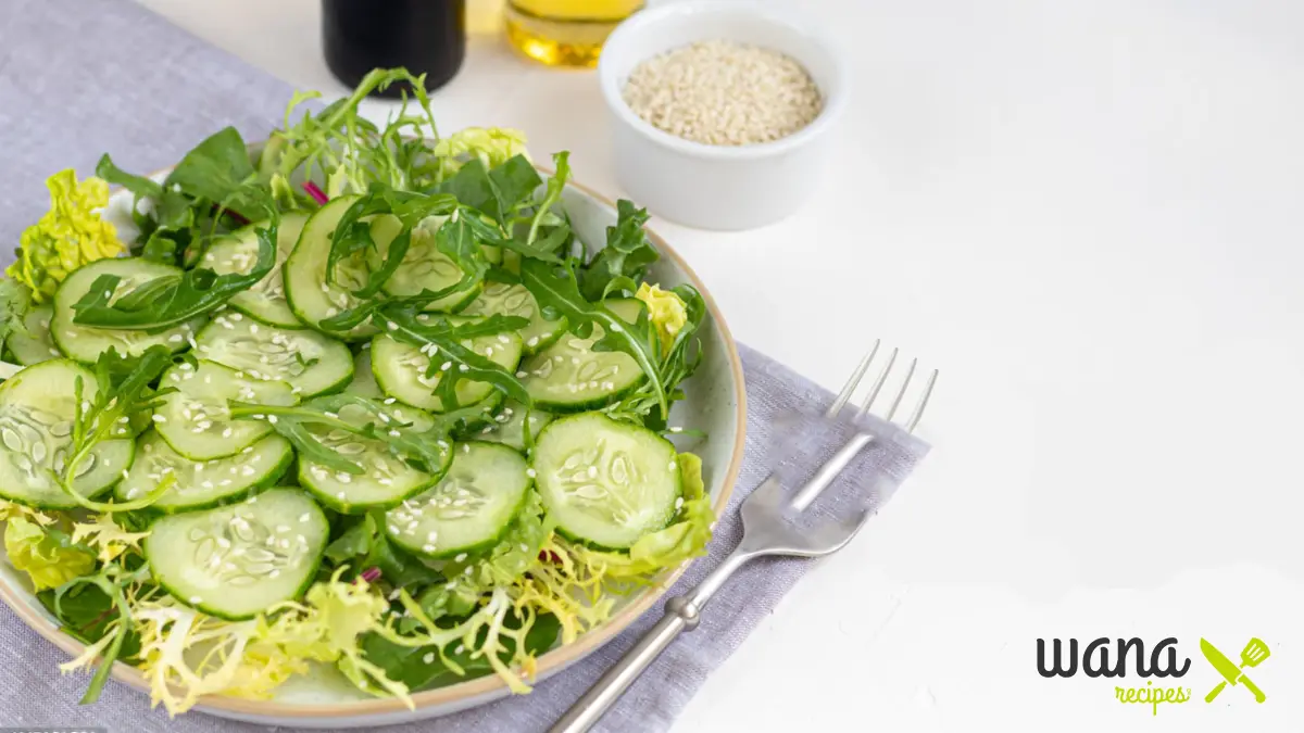 Freshly prepared viral cucumber salad recipe with sesame seeds, chili flakes, and herbs served in a white bowl