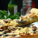 Freshly baked breakfast pizza with eggs, cheese, sausage, and vegetables served on a wooden board in a school cafeteria.