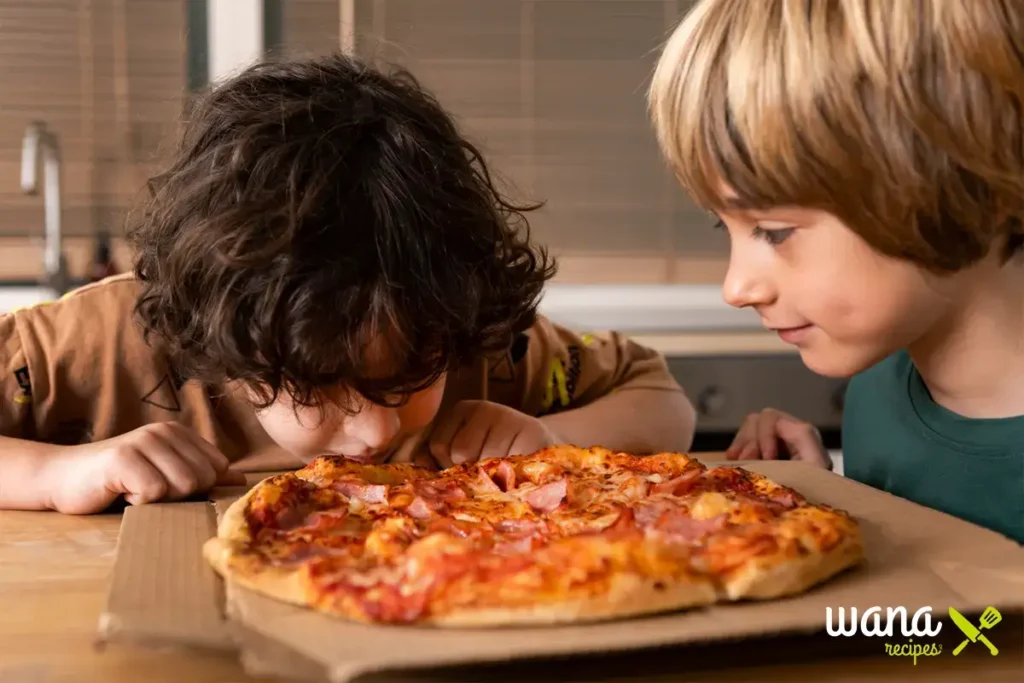 Hands spreading pizza dough on a baking sheet to prepare breakfast pizza.