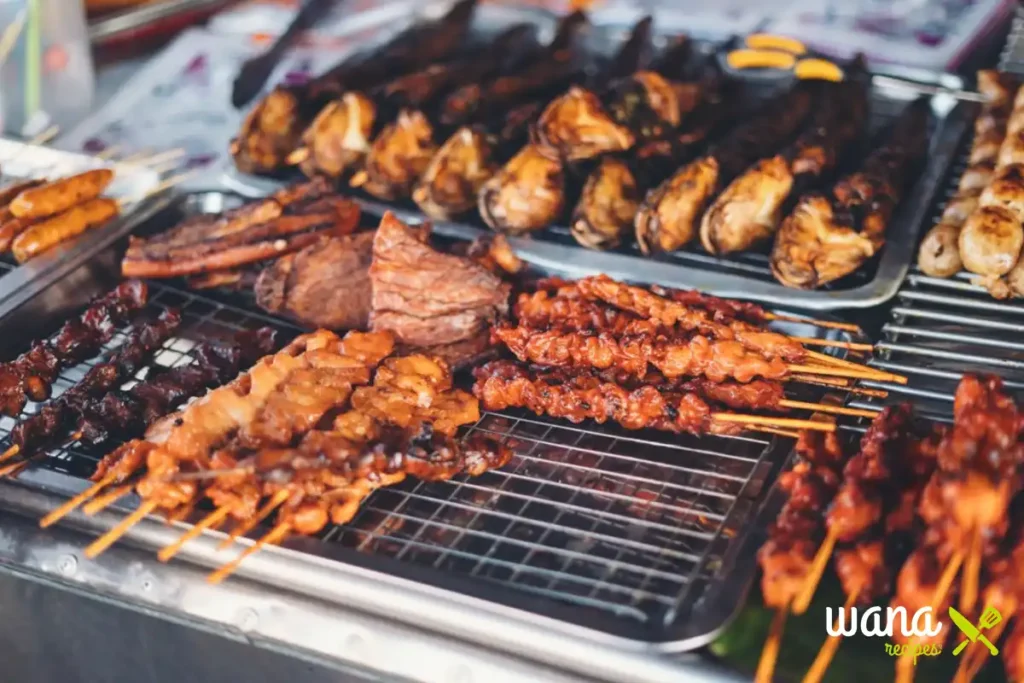 A variety of grilled meats and seafood on skewers displayed at an Asian street food stall.