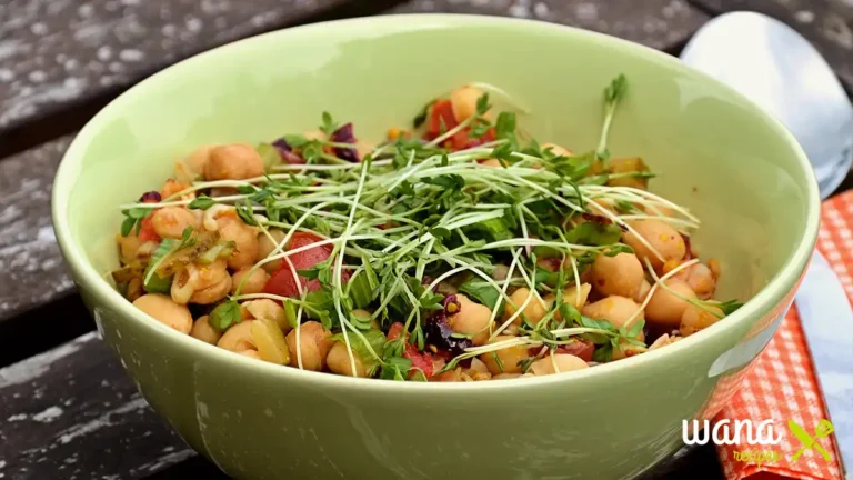 A fresh and colorful chickpea and flaxseed salad served in a bowl, garnished with cherry tomatoes, parsley, and a drizzle of olive oil.