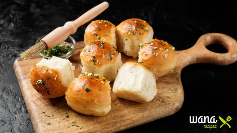 Freshly baked no-yeast dinner rolls on a wooden tray, golden brown and fluffy, perfect for any meal.