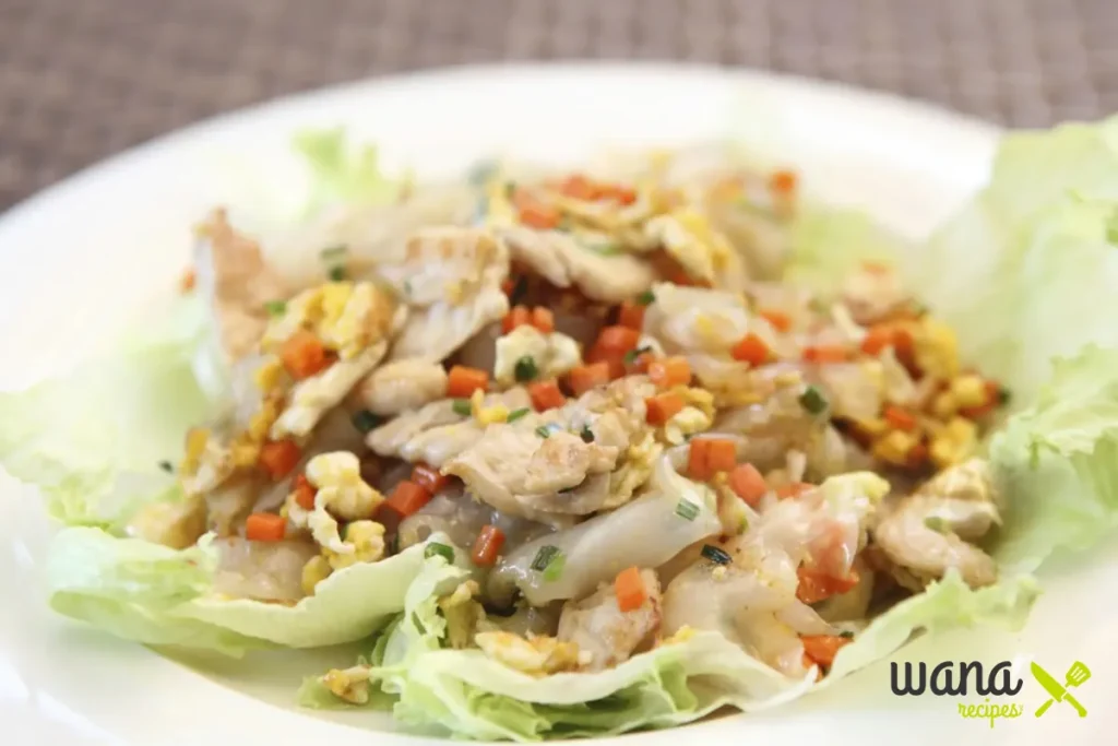 Chicken and vegetable stir-fry served on fresh lettuce leaves as a low-carb meal