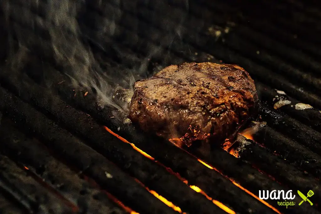 Juicy steak sizzling on a hot grill with flames underneath – perfect steak auf dem grill experience.